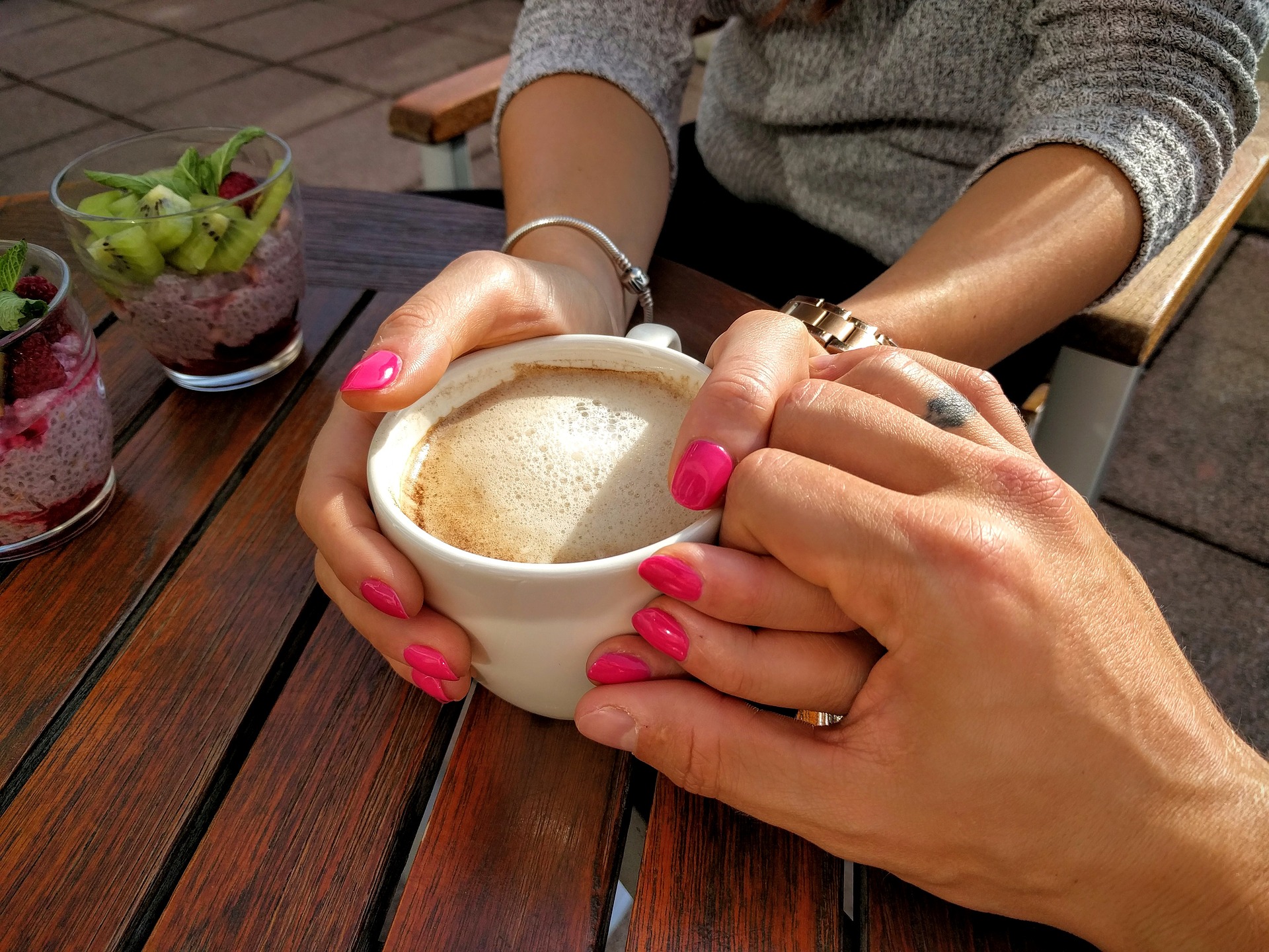 Couple holding hands with coffee
