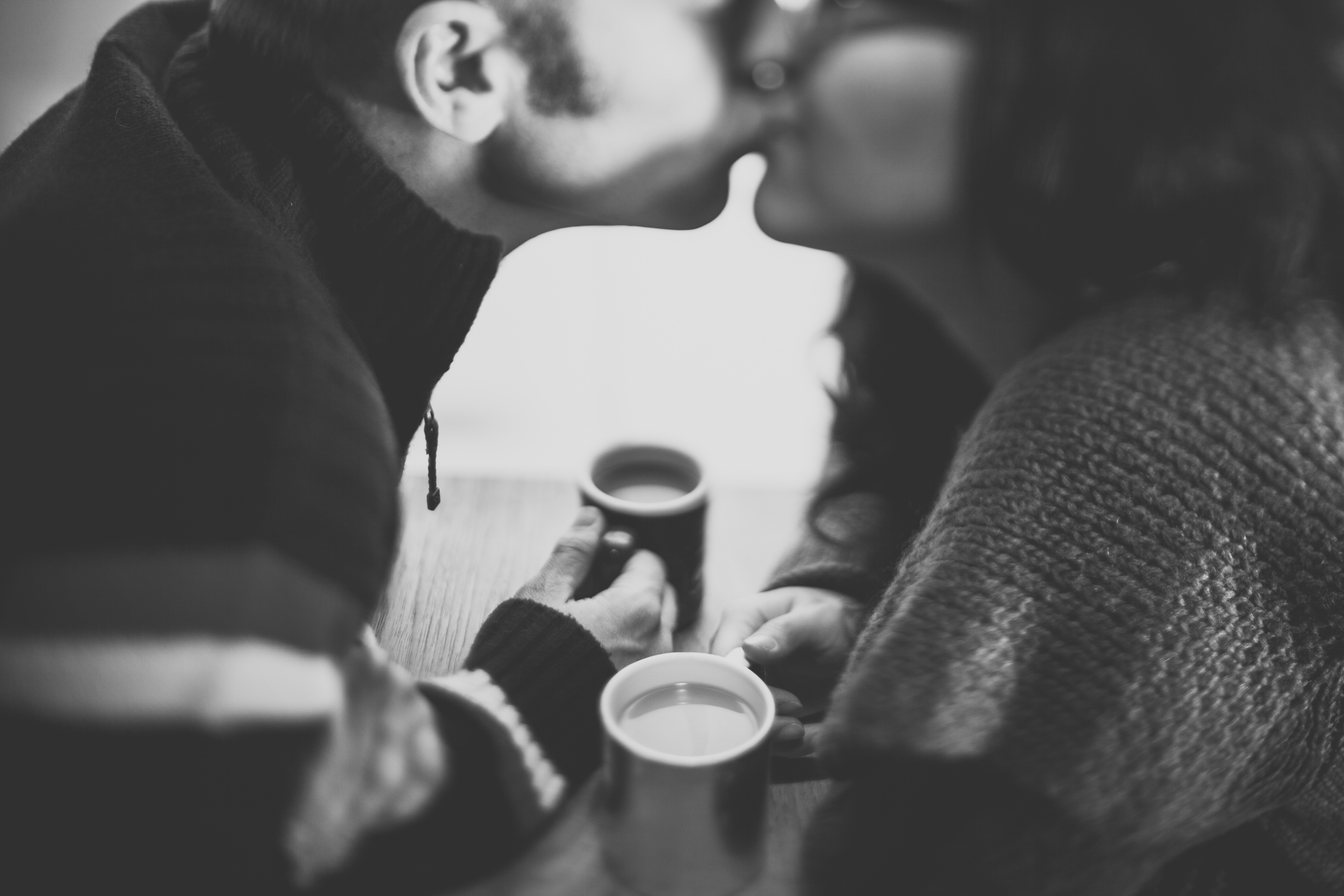 Couple kissing over coffee