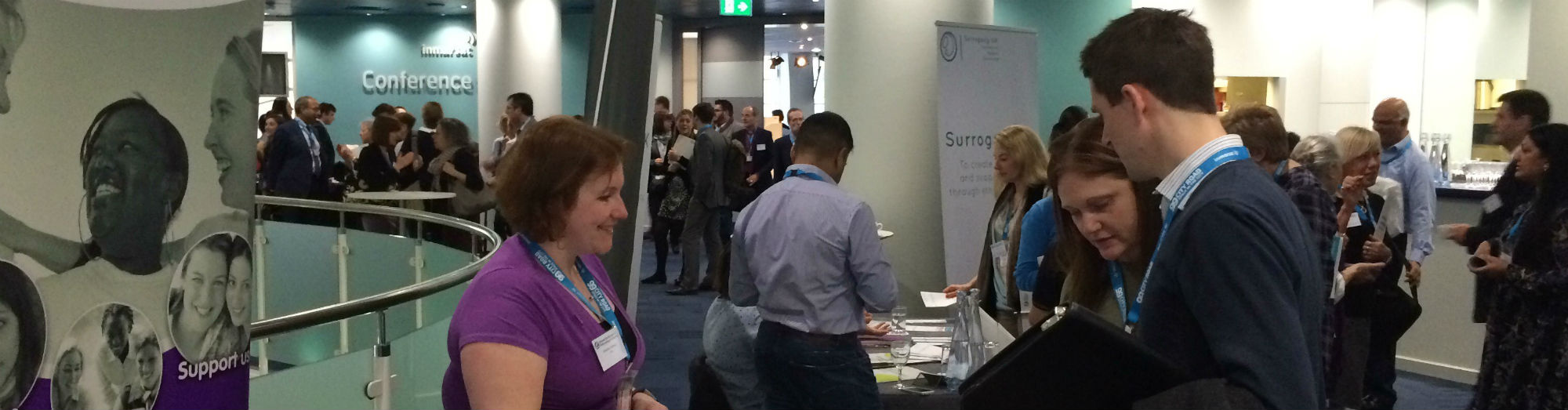 Two people talk to a conference exhibitor at the HFEA annual conference 2017