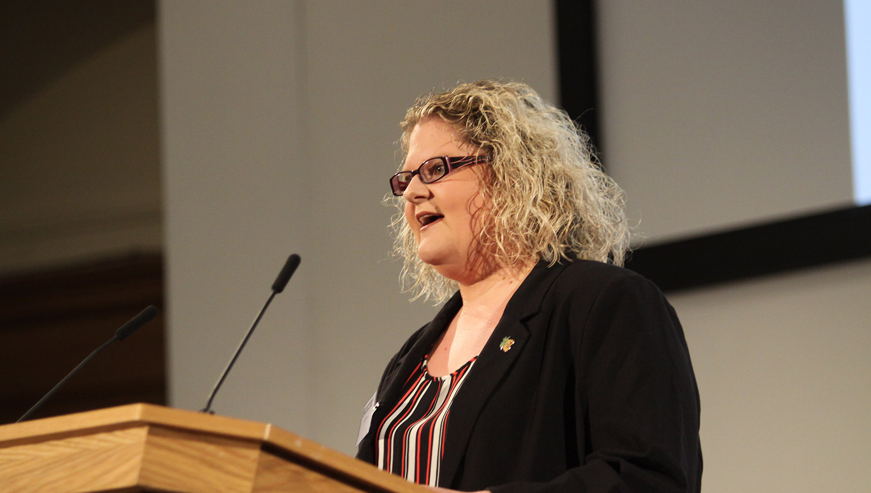 Louise Brown addresses an audience behind a plinth at the HFEA annual conference