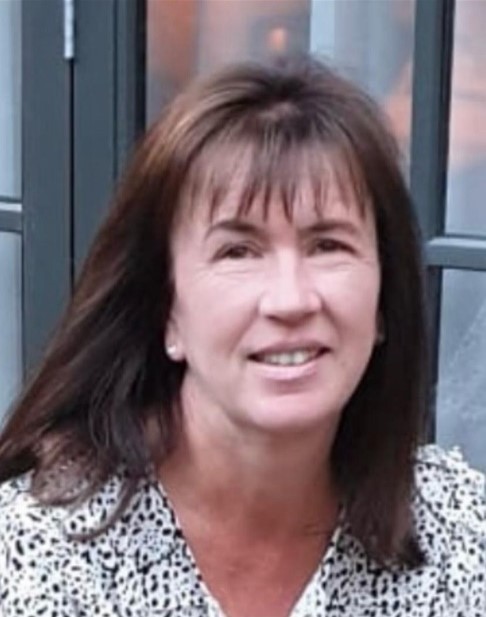 A photo of Sarah smiling.
